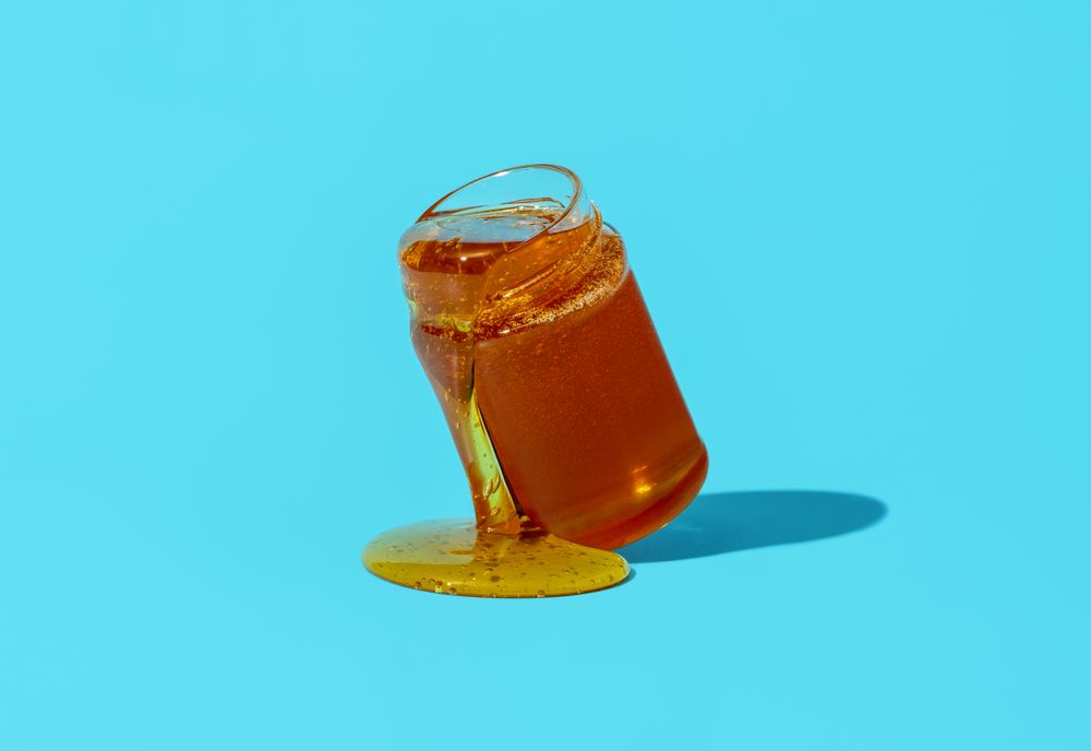 Honey jar isolated on a blue background
