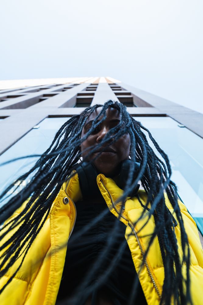 Black woman against skyscraper in city