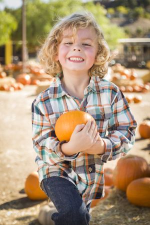 Boy With His Pumpkin at a Pumpkin Patch.