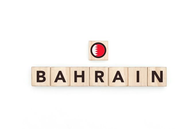 Wooden blocks bearing the name and flag of Bahrain.