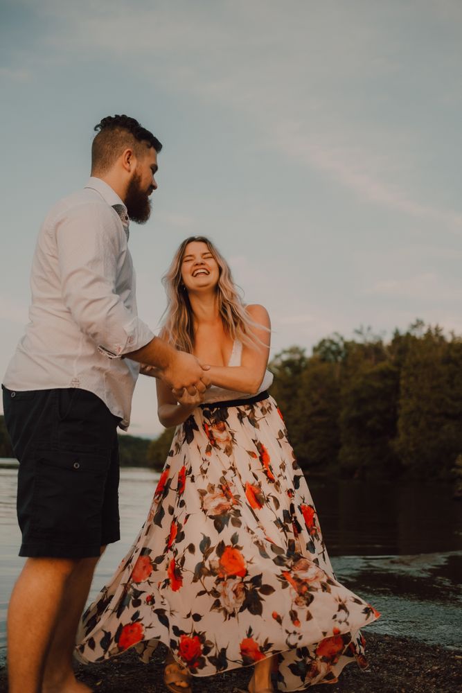 Loving couple standing ankle deep in water on beach