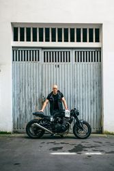 Builder posing with a motorcycle