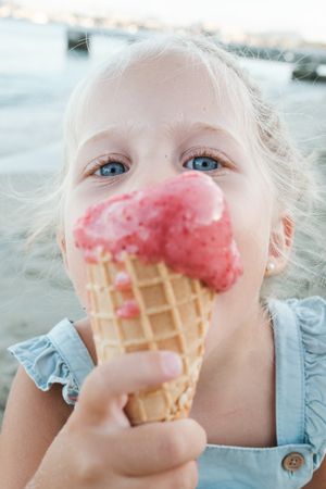 Funny kid enjoying ice cream cone in nature