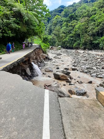 Tanah Datar, Indonesia - May 12, 2024: Dangerous part of landslip road section after cold lava flash floods, natural disasters in Lembah Anai, Sepuluh Koto, Tanah Datar Regency, West Sumatra, Indonesia