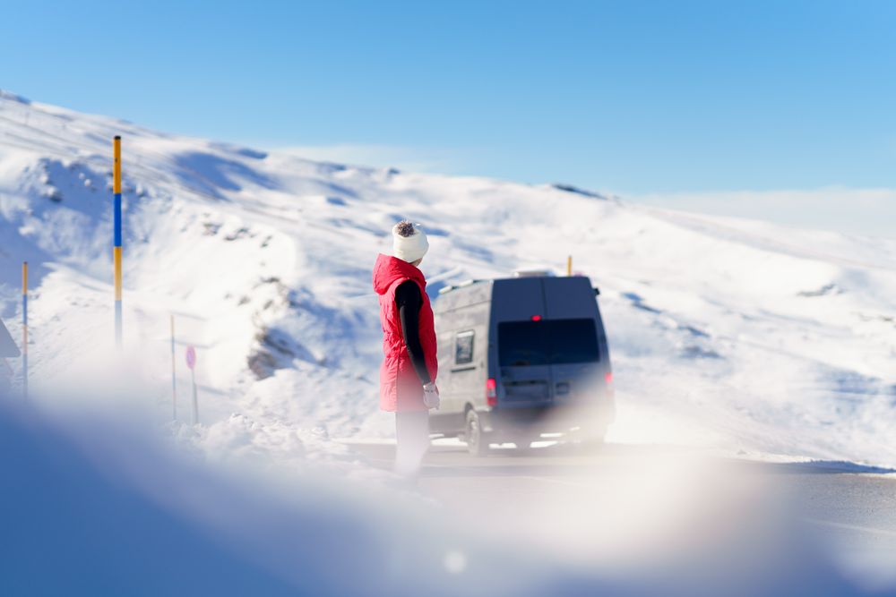 Seeing woman in the distance on mountain with van