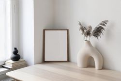Table with modernist vase and decorative reeds and mock up frame