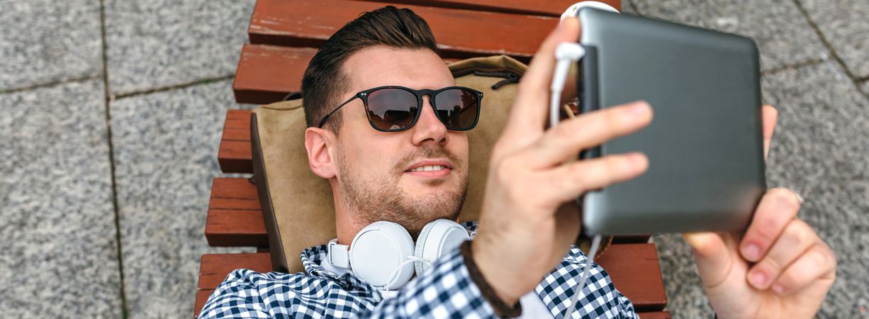 Man using tablet outdoors