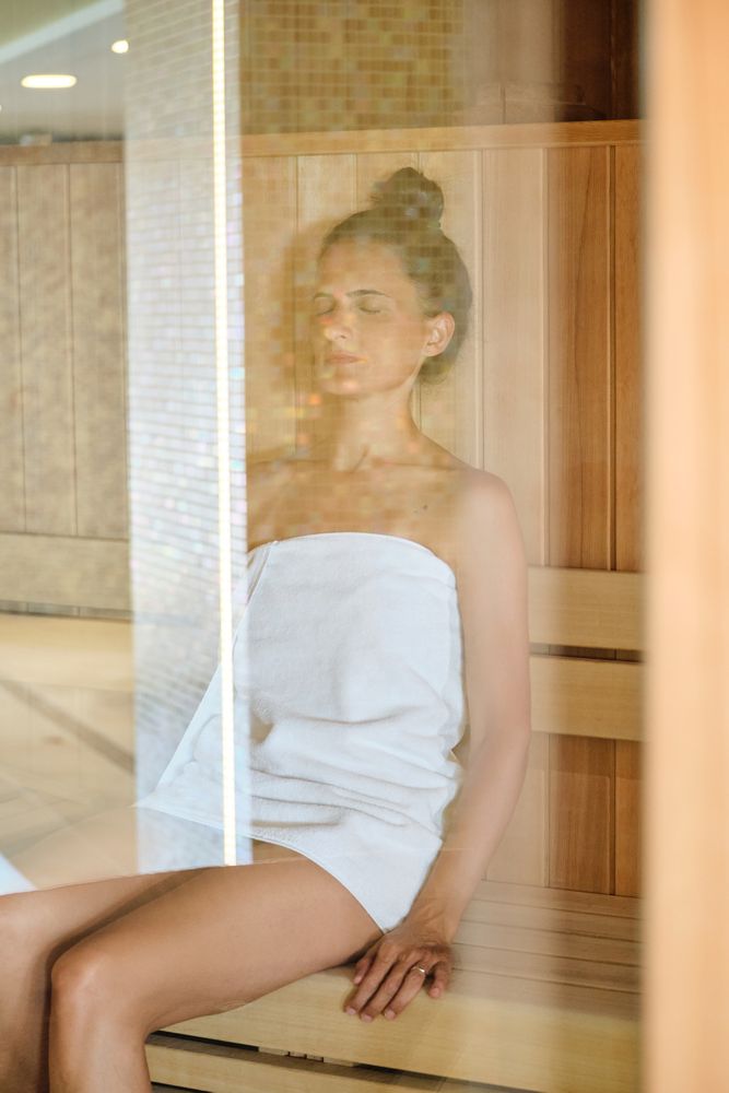 Female sitting in sauna in spa center