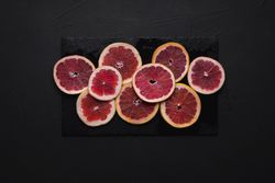 Blood orange slices on a dark table