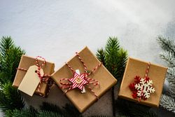 Three Christmas gifts with branch and copy space