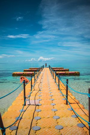 Orange dock on blue sea under blue sky