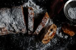 Pieces of Stollen near sieve and autumn leaves