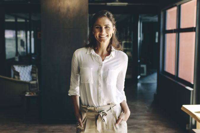 Smiling businesswoman standing in office