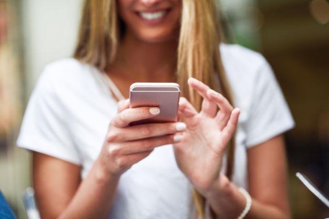 Female hands typing text message on cellphone