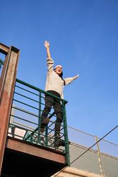 Screaming woman raising hands up on balcony