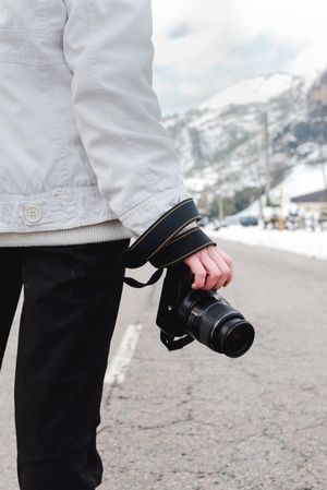 Anonymous person standing on road in countryside