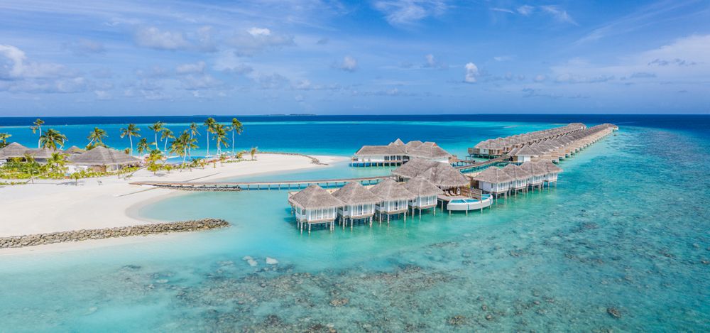 Overwater bungalows in a Maldives beach resort, wide shot