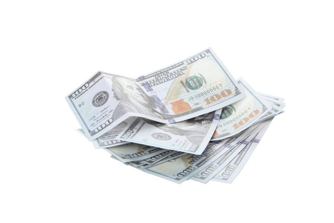 Stacks of American cash money, isolated on light background