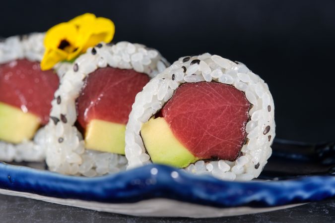 Delicious uramaki rolls served on marble tray