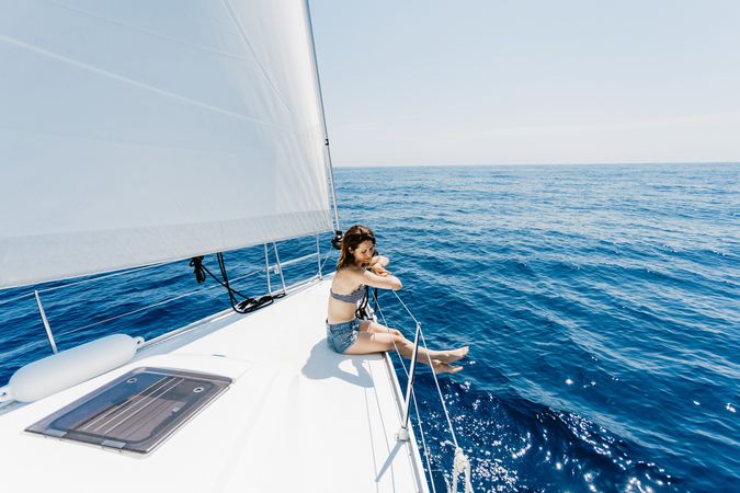 Woman in swimsuit sitting on boat