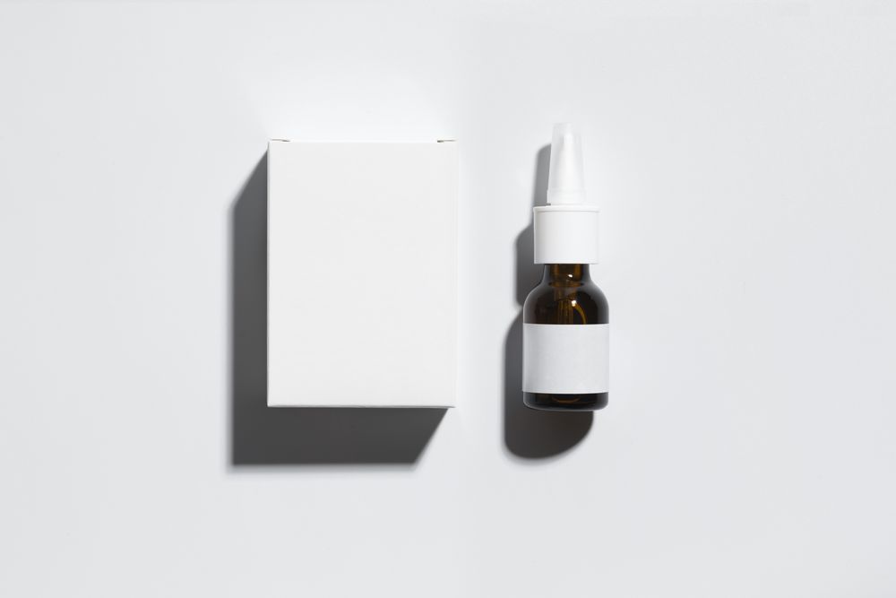 Mockup of a box and an amber glass bottle