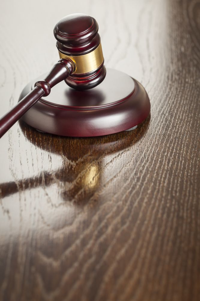 Wooden Gavel Abstract on Reflective Table