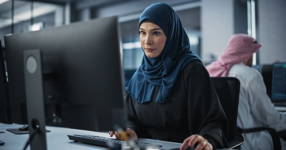 Young Arab Female Artificial Intelligence Engineer Working on Computer in a Technological Office.
