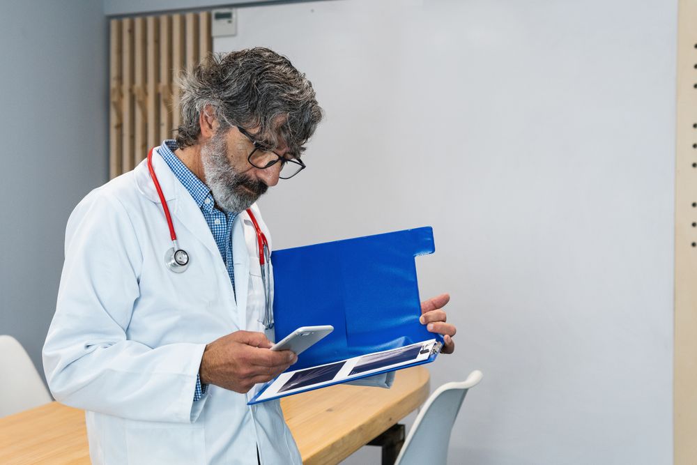 Doctor using smartphone in medical office