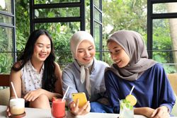 Group of Cheerful and Asian Female Friends Hanging Out at a Restaurant