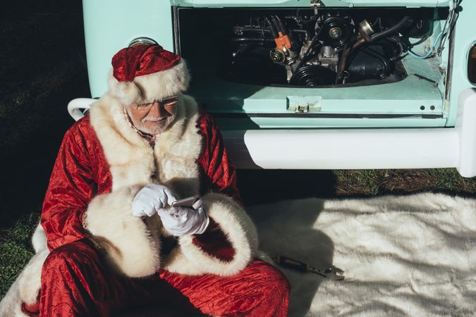 Santa Claus resting by old van