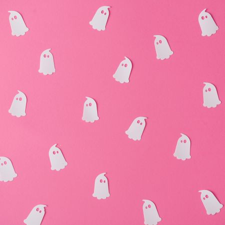 Pattern made of ghosts on pink background