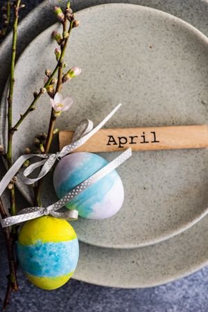 Pastel Easter eggs & branch on ceramic grey plate