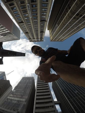 Low angle view of man standing between high-rise buildings