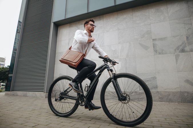 Side view of an entrepreneur commuting to office on a bike