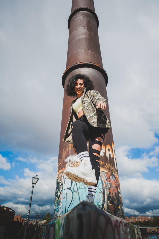 Black woman laughing in an urban environment