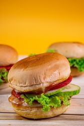 A sandwich with lettuce and tomato on top of a bun