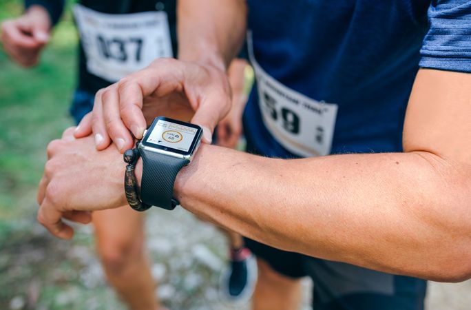 Sportsman looking a smartwatch