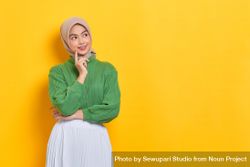 Smiling woman in headscarf looking to the side and thinking 5Xvy7b