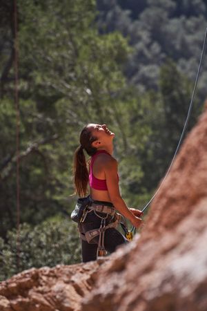 Woman in harness looking at mountain