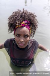 Portrait of a young Black woman with pink headband in the water 4ZeEZO