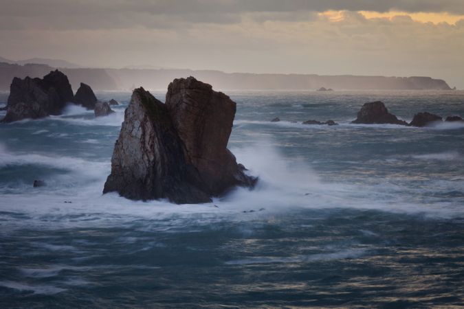 Storm with blustering waves on rocky coast