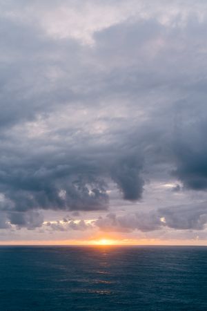 Grassy shore near stormy sea in evening