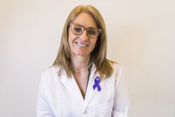 Female doctor using breast cancer awareness ribbon.