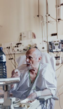 Older man admitted to a hospital room.