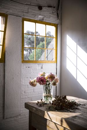 Bunches of flowers in vases on table