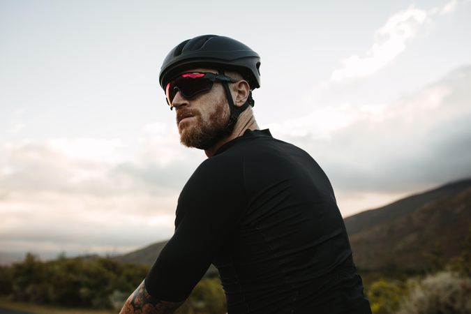 Cyclist looking over his shoulder against a scenic view