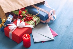 Gift bag overturned on the table with presents coming out
