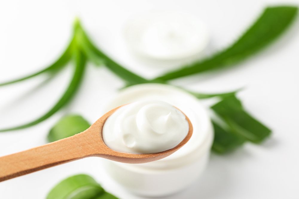 Composition with natural treatment accessories on light background, space for text. Aloe vera