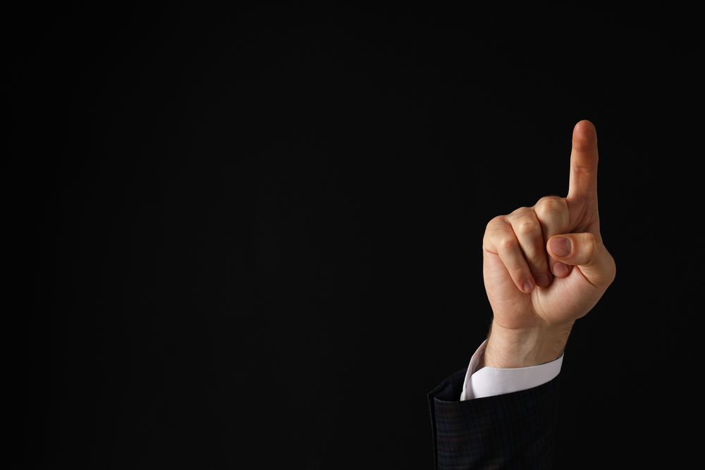 Businessman's hand close-up on a dark background