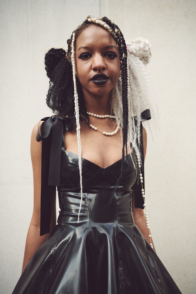London, England, United Kingdom - September 18 2021: Woman in PVC dress with monochrome braids